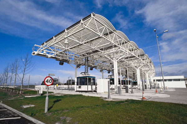 Aluminum toll booth structures, including aluminum frames and auminum lane dividers